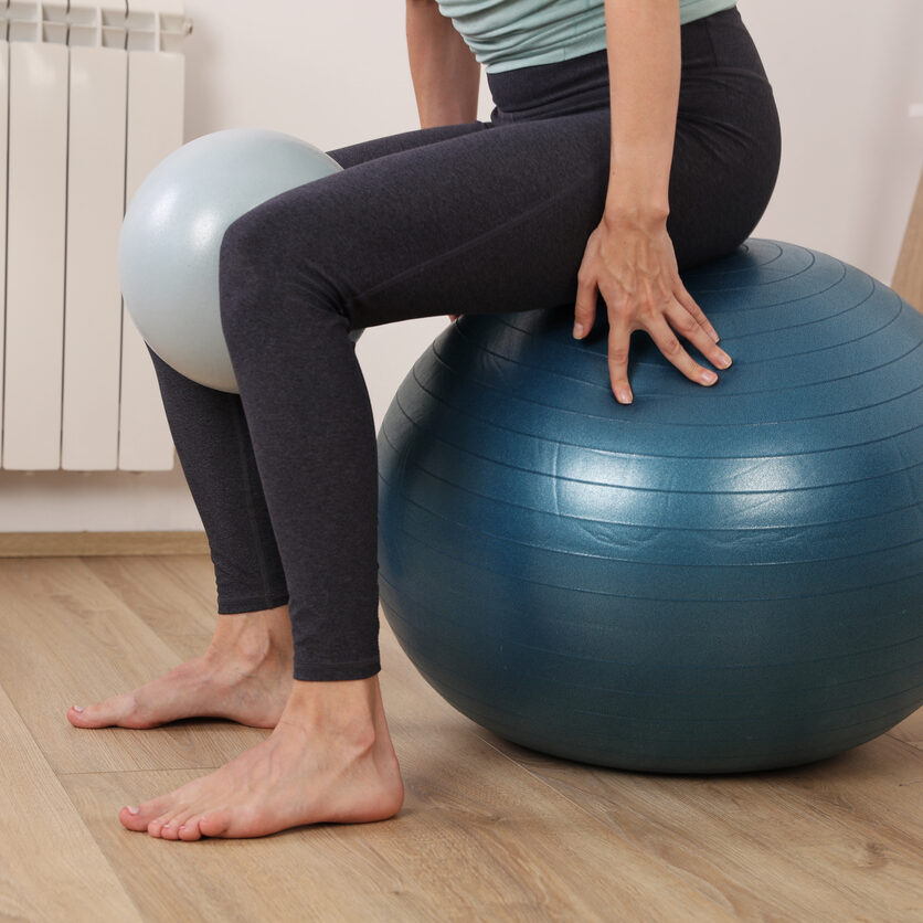 Pilates workout for women, female workout with fitness ball, balance exercises. Leg and Glute Stability Ball Exercises